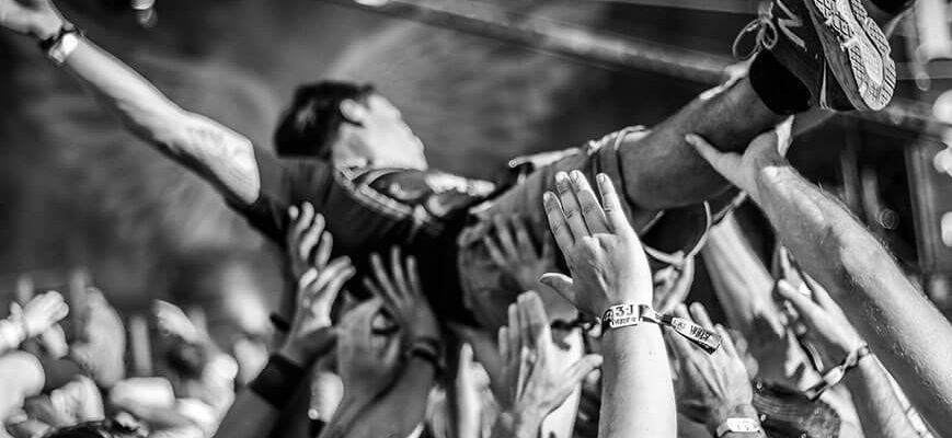 how-to-write-craft-of-writing-creative-audience-black-and-white-shot-of-a-crowd-surfer-at-a-rocking-punk-gig