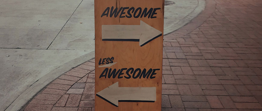 a sandwich board with "more awesome" and 'less awesome" written on it how-to-write-a-year-6-creative-in-8-steps