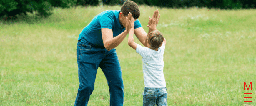 Child and parent high-fiving