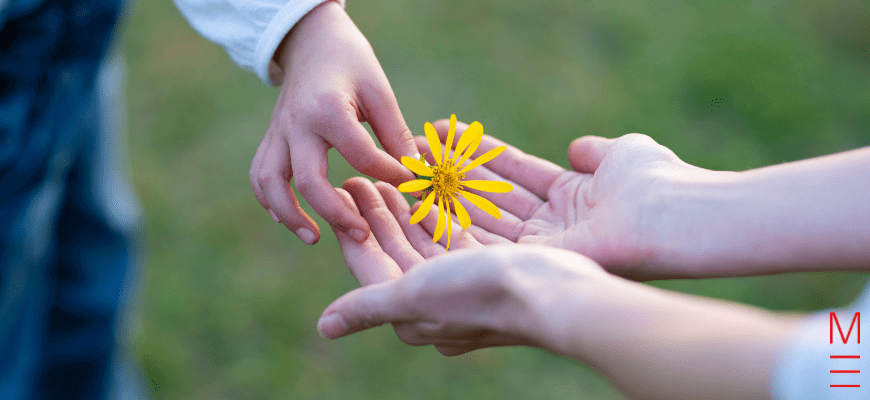 Year 6 student giving flower to parent