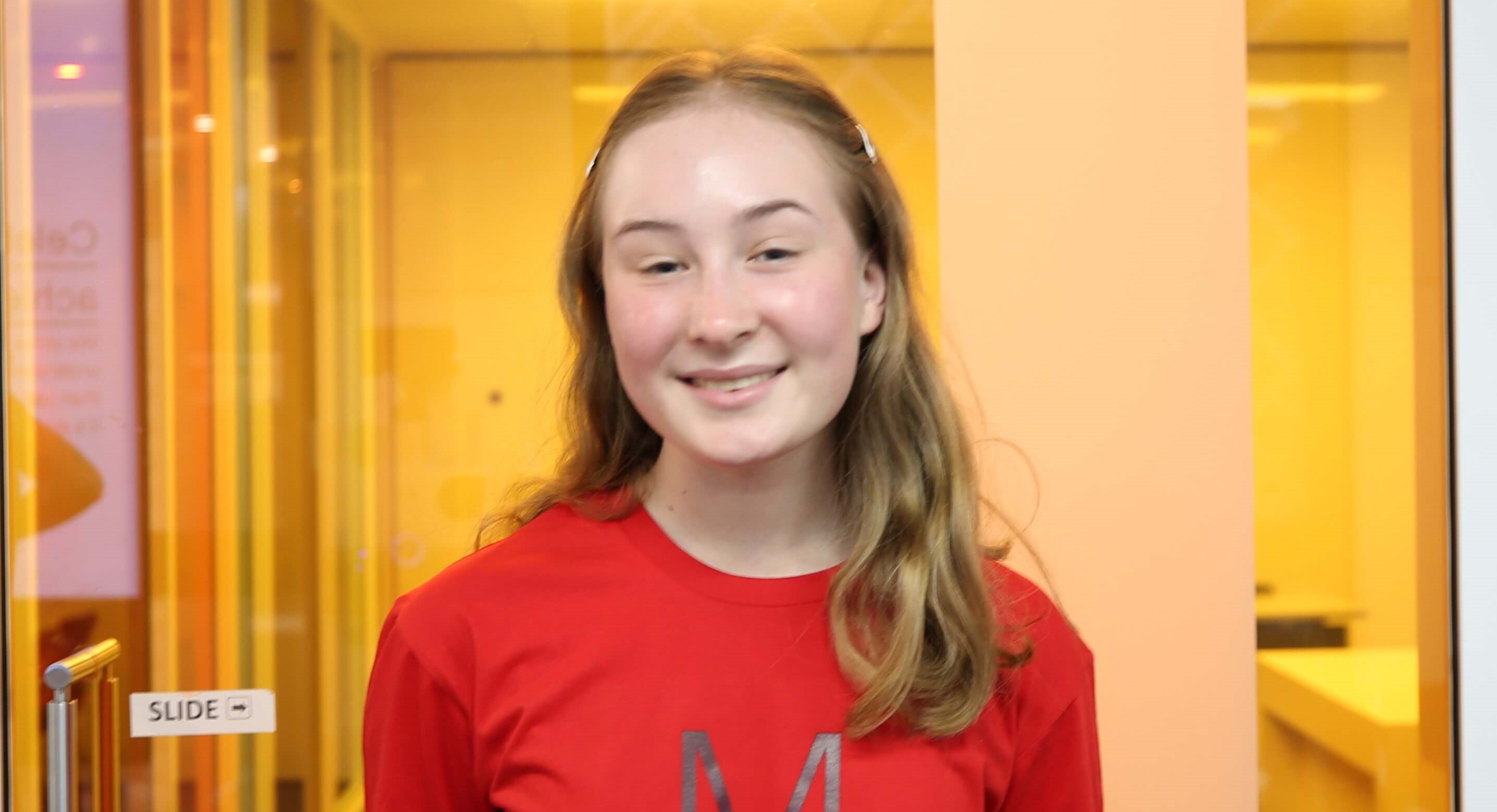 Matrix student Nia smiling in front of yellow classroom as she rebounds from poor results