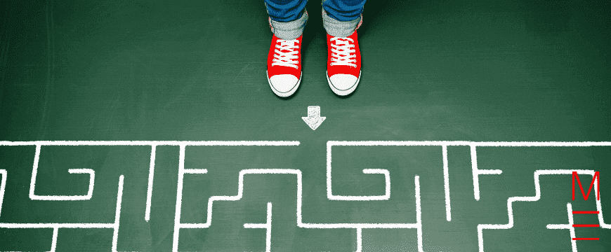 Year 3 student standing in front of a maze