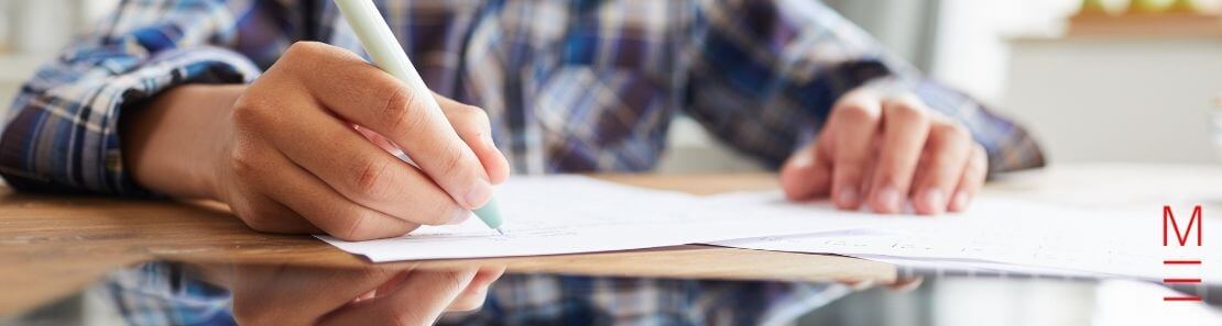 matrix education student writing on exam paper with pen preparing for selective school exam