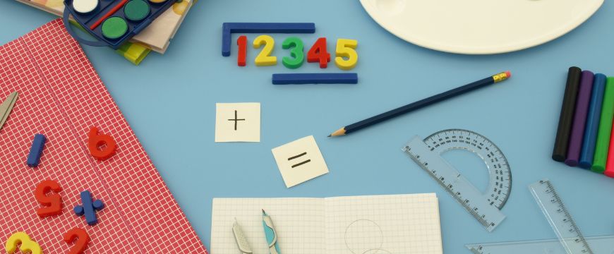 matrix education desk with maths learning equipment, including pencils, protractors, rulers and small numbers. 