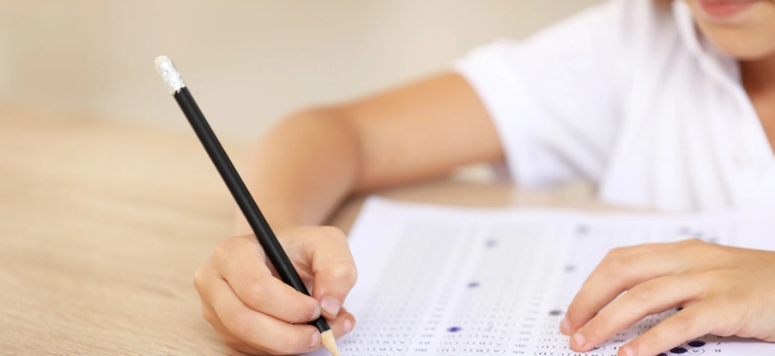 matrix education Student completing an OC Test with multiple-choice answer sheets.