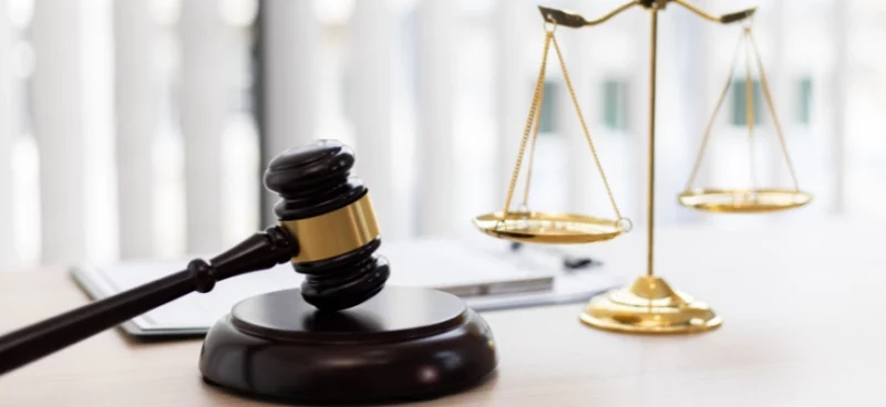 a judge's gavel next to a balanced scale