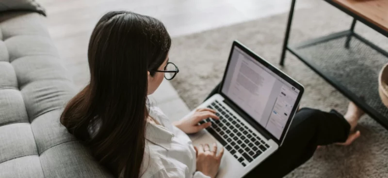 A woman working on a laptop from home