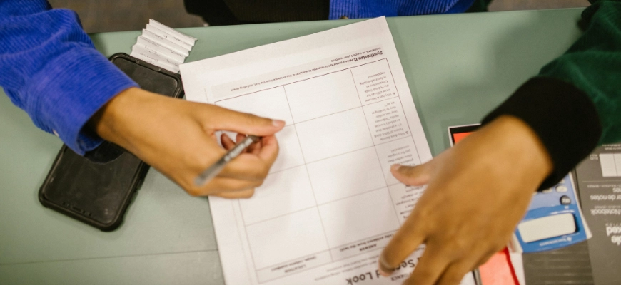 Student working on a worksheet in a classroom.