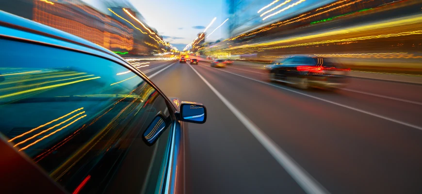 matrix education A car driving at high speed, creating streaks of light to illustrate motion