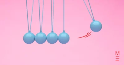 Newton's cradle with blue spheres against a pink background, symbolising motion from the Physics VCE exam