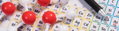 matrix education A molecular model placed over a periodic table, symbolising the 2024 VCE Chemistry Exam