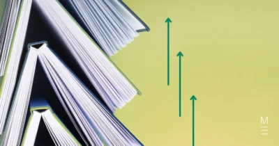 Open books with teal arrows on a green background, symbolising progress.