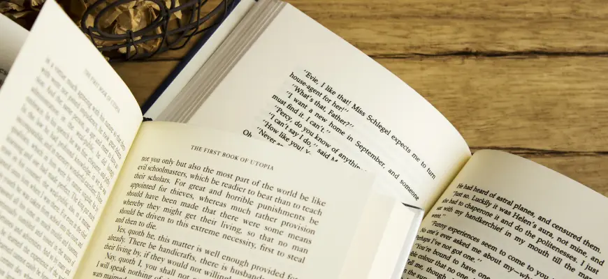 Open books with visible text on a wooden table