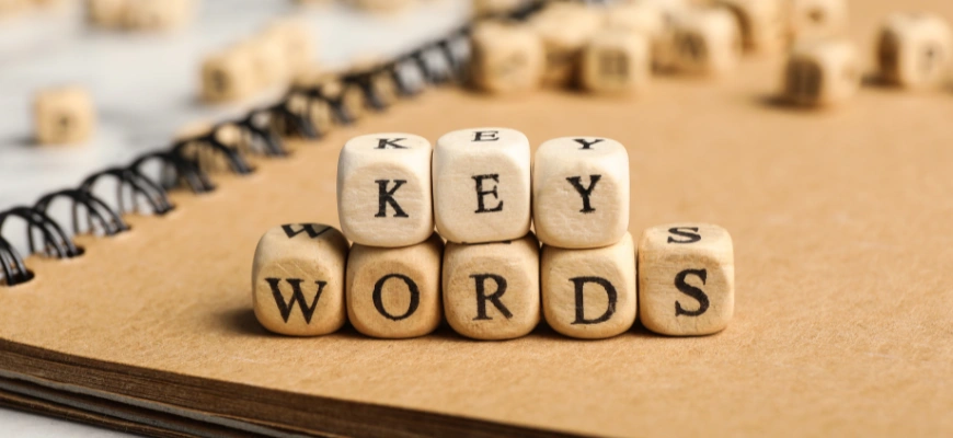 Stacked wooden blocks spelling 'key words'