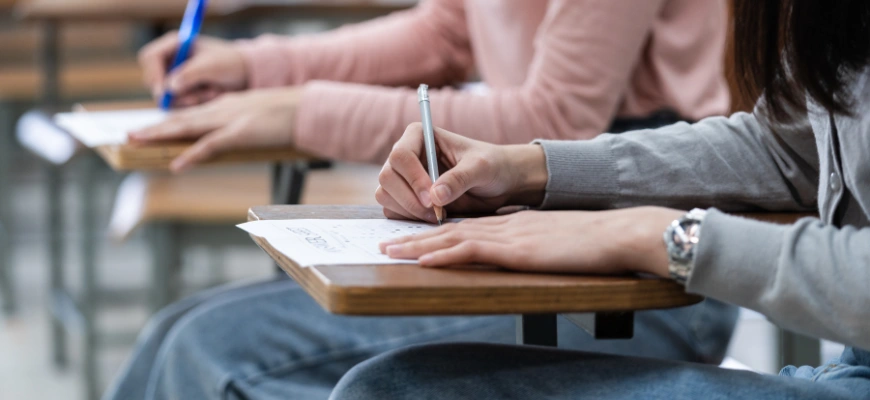 Students writing in an exam setting, symbolising taking a test with VCAA command terms