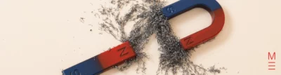 U-shaped magnet with iron filings showing magnetic field lines