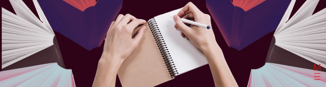 Hands writing in a notebook surrounded by open books, symbolising study for VCE English essays