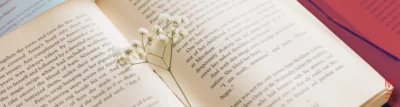 Open book with flowers resting on the pages, symbolising creativity for VCE English section b.