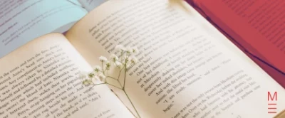 Open book with flowers resting on the pages, symbolising creativity for VCE English section b.