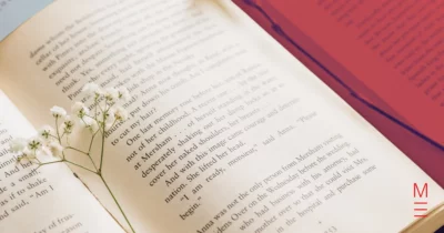 Open book with flowers resting on the pages, symbolising creativity for VCE English section b.