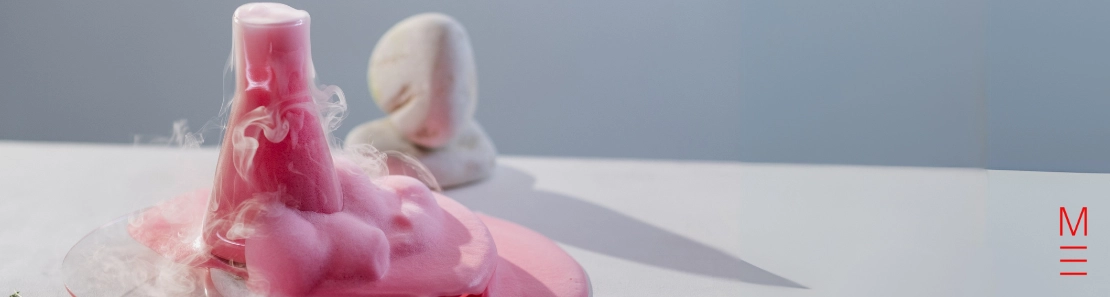 matrix education A chemical reaction in a beaker with pink foam overflowing with artistic vapor effects