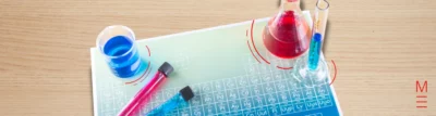 matrix education Periodic table under colourful beakers containing red and blue liquids