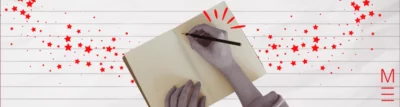 matrix education Hands writing in a notebook with red stars symbolising creative writing