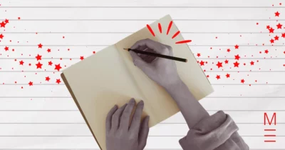 matrix education Hands writing in a notebook with red stars symbolising creative writing