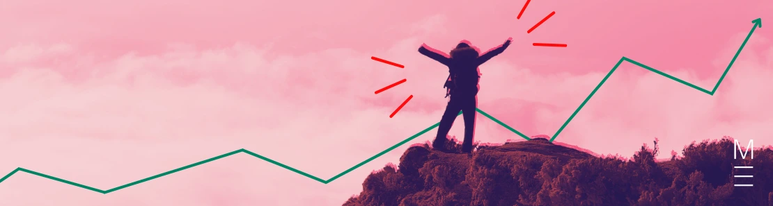 Person standing victorious with arms in the air atop a mountain.