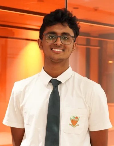 Jai, a HSC student, standing in his James Ruse uniform smiling against an orange Matrix background.